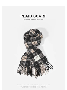 Detailed view of soft black and beige plaid scarf with fringe on white background