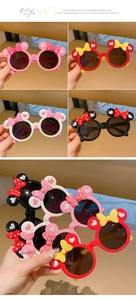 Detail view of colorful bow-knot round frame sunglasses for kids in four distinct colors