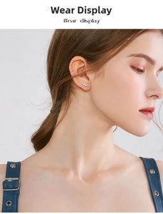 Detailed view of sterling silver curved stud earrings with white zircons on model ear