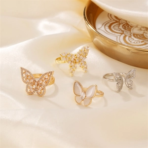 Elegant butterfly pearl and zircon open rings set on silk background for women