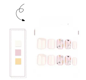 Detail of 10-piece press-on nails featuring floral art and gold foil on cream base