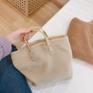 Plush lamb wool small square handbag in beige with brown leather handles and metal rivets