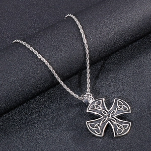 Detail of silver stainless steel Celtic knot cross pendant on twisted rope chain