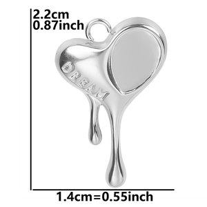 Detailed view of silver heart pendant with DREAM engraving and dimension labels