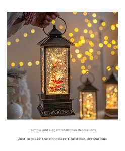 Detail of a vintage bronze Christmas snow lantern featuring Santa Claus and warm LED light