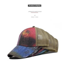 Close-up of ponytail baseball caps with tie-dye print and breathable mesh design