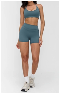 Detail of misty blue ribbed yoga set featuring halter neck sports bra and high waist shorts