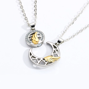 Macro detail of magnetic sun and moon couple necklaces with zircon and gold wings