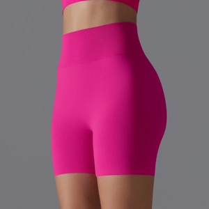 Detailed texture of seamless high-waisted fuchsia yoga shorts with ribbed waistband