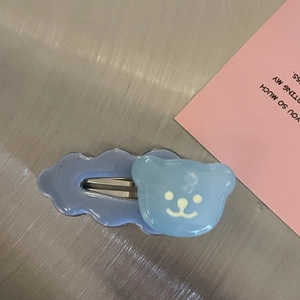 Cute sky blue cloud hair clip with a bear charm on a minimalist background