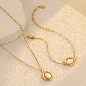 Elegant gold-tone stainless steel jewelry set with white shell oval charms and chain