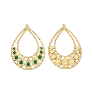 Detail of golden teardrop earring base with green gemstone inlay on white background