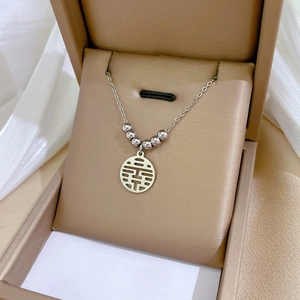 Close-up of silver Double Happiness pendant necklace in a luxury jewelry box