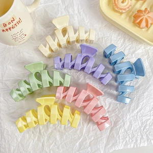Set of large pastel glitter hair claws in six colors displayed on white aesthetic background