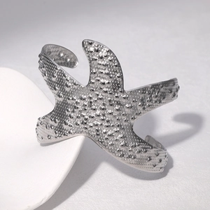 Modern starfish cuff bracelet in polished silver finish with granulated texture details