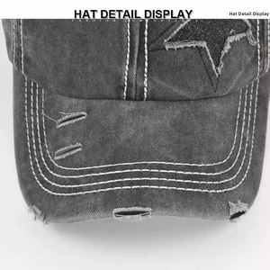 Detail view of washed denim baseball hat featuring distressed holes and sequin star