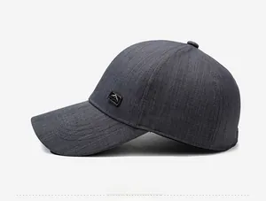 Side view of dark gray baseball cap with mountain logo patch and textured fabric