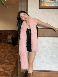 Close-up of a soft pink plush faux fur scarf showing thick texture and warmth detail