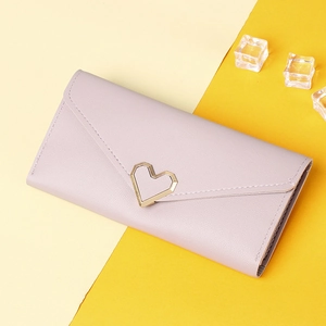 Close-up of lilac purple trifold wallet with lychee leather texture and gold heart buckle