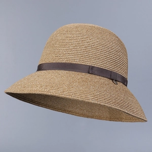 Detailed side view of a breathable Japanese style women's straw sun hat with a brown ribbon