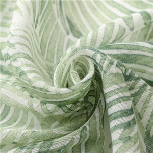 Close-up of the breathable bali yarn texture with green banana leaf print and soft fabric