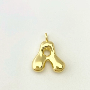 Macro detail of puffy 3D balloon letter A pendant in polished gold finish