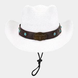 Detail of white straw cowboy hat featuring bull head metal buckle and turquoise band