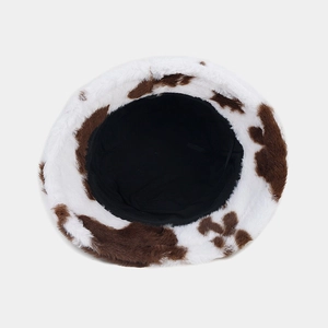 Detailed top view of faux fur cow print bucket hat with soft plush texture and black lining