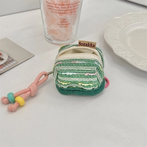 Detail of green tweed earphone case with colorful beaded zipper and brand tag