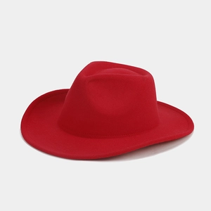 Detailed view of red felt fedora hat with elegant pinched crown and wide brim texture