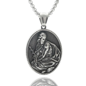 Macro detail of oval stainless steel pendant with vintage religious portrait and chain