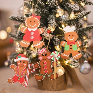 Set of four cartoon gingerbread man Christmas ornaments hanging on a decorated tree
