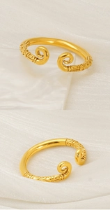 Macro detail of golden Sun Wukong ring featuring intricate engraved traditional patterns