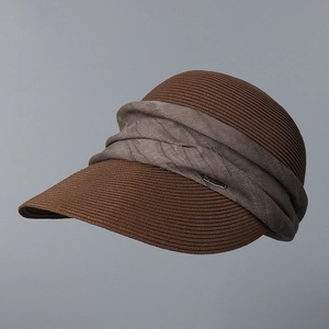 Detailed macro view of woven straw sun hat with textured fabric band and metal buckle