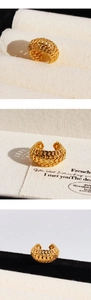 Macro shot of gold-plated chunky ear cuff with detailed hollow chain link texture