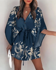 Detail of V-neck summer dress in navy blue with cream leaf print and drawstring waist