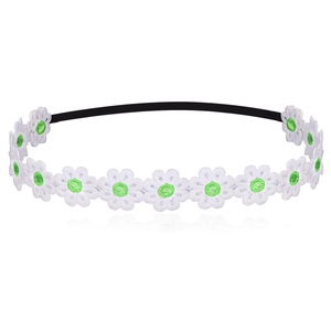 Detail of white embroidered daisies with green centers on a soft black baby headband
