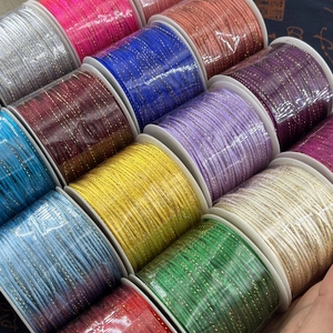Detailed view of colorful metallic thread spools for DIY jewelry and braided bracelets