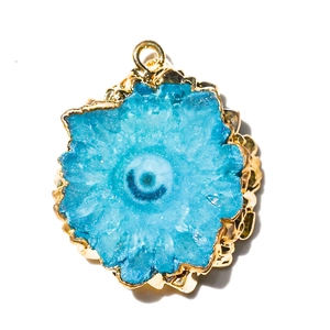 Close-up of blue natural crystal cluster pendant with a gold-plated edge and top bail