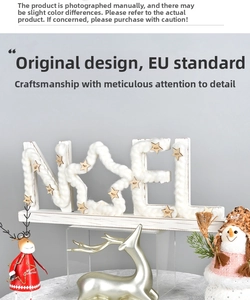 Detail of wooden NOEL Christmas ornament with white textures and festive reindeer decor