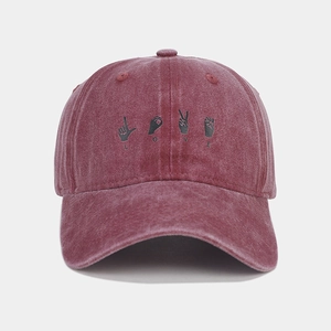 Detail of vintage washed cotton baseball cap featuring LOVE hand gesture graphics