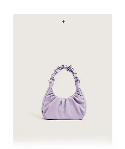 Detail view of the soft ruched texture and cloud-like design on the lavender handbag