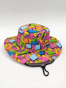 Detail of colorful geometric pattern bucket hat with black windproof cord and side air vents