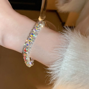 Close-up of a silver buckle bracelet featuring multi-row colorful AB crystals