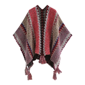 Ethnic knit shawl cloak with wavy patterns and tassel fringe detail on white background