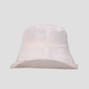 Detailed texture of a breathable beige lace bucket hat for summer sun protection