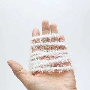 Macro shot of white iridescent feather yarn ribbon with metallic tinsel for DIY gifts