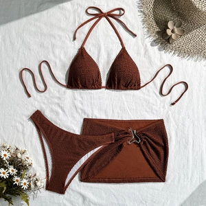 Close-up of three-piece burgundy bikini set featuring seersucker textured fabric