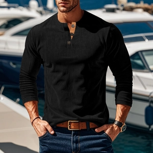 Close-up of a black long-sleeved Henley shirt with button neckline and ribbed texture