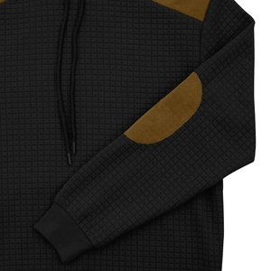 Detail of men's quilted hoodie with brown elbow patches and waffle texture fabric